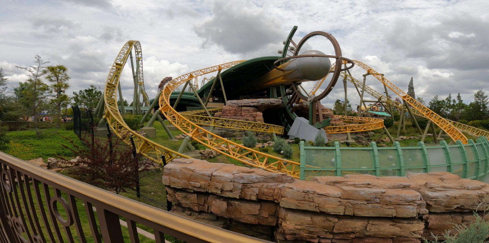 Stardust Racers' yellow Photon track looping past the ride's comet-shaped launch capsule in Celestial Park