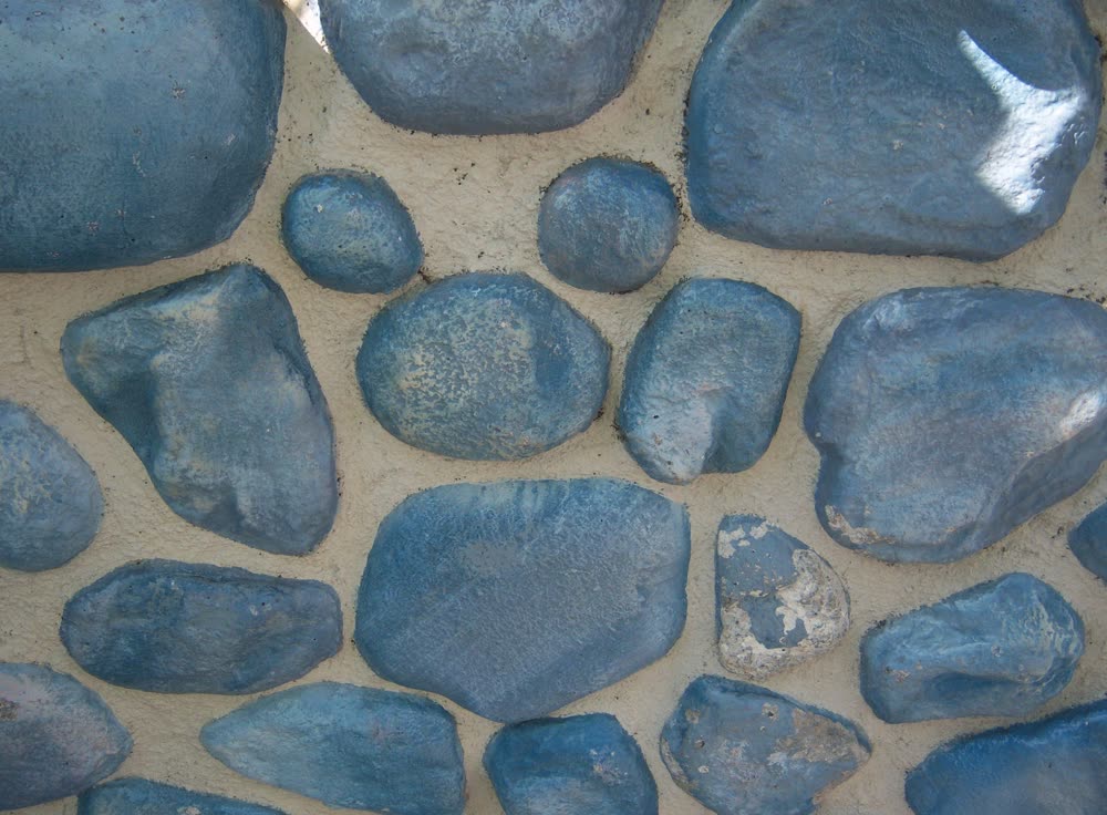 A real Hidden Mickey formed by three stones set into a park wall